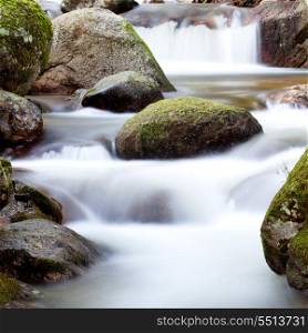 Nice creek with clear water flowing between the rocks