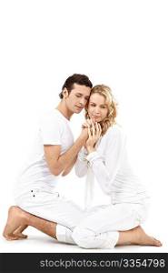 Nice enamoured couple sitting on a white background