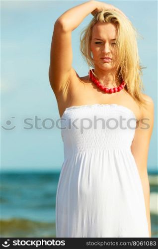 Nice female enjoying nature and beach.. Nature beach outdoors and female. Nice lady enjoying nature and beach. Young woman wearing long white dress and beautiful red necklace.