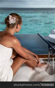 Nice female on spa resort, pretty girl sitting in the bath and enjoying amazing seaview, luxury resort, Maldives