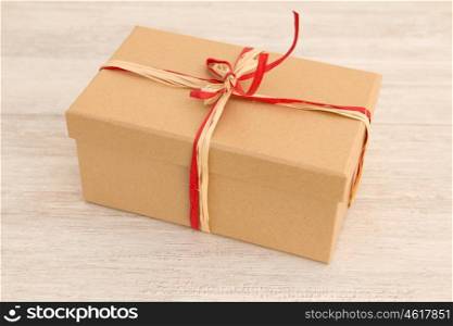 Nice gift wrapped with brown paper and decorated with white ribbons and red