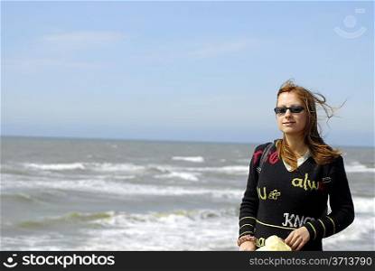 nice girl with sunglases at sea shore