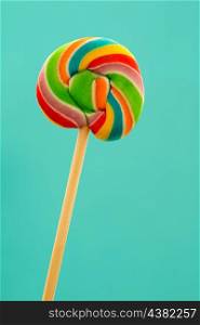 Nice lollipop with many colors in a spiral on a blue background