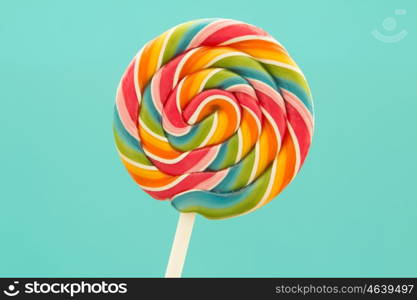 Nice lollipop with many colors in a spiral on a blue background