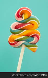 Nice lollipop with many colors in a spiral on a blue background