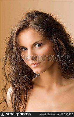 nice portrait of a cute brunette with moved hair and and brown eyes