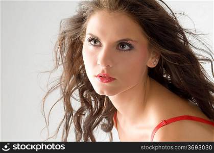 nice portrait of a cute brunette with wind in hair