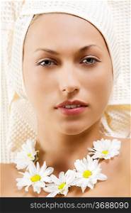 nice portrait of a young woman with bath towel and flowers on neck