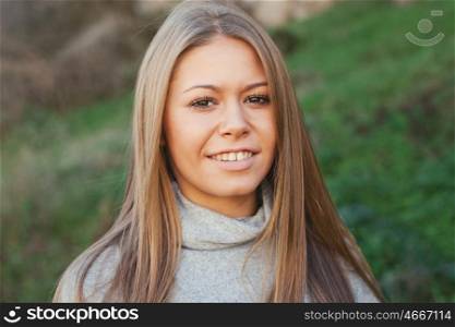 Nice portrait of blonde girl with green grass of background