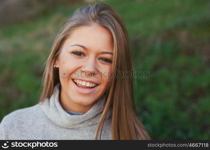 Nice portrait of blonde girl with green grass of background