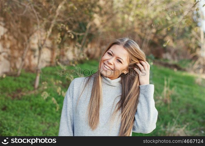 Nice portrait of blonde girl with green grass of background