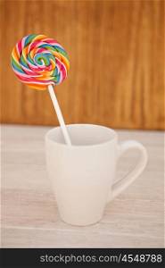 Nice round lollipop with many colors in a spiral in a cup