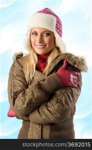 nice shot of beautiful blond girl in winter breakwind jacket scarf gloves and pink hat