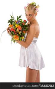 nice shot of young and beautiful woman in short white dress looking at her flowers bouquet