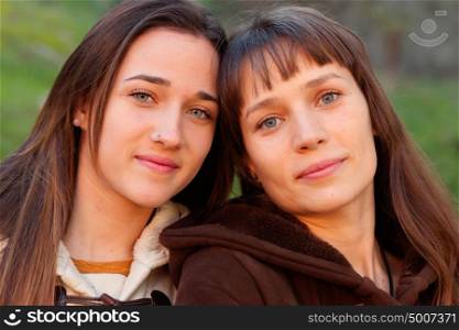 Nice sisters with blue eyes in a park