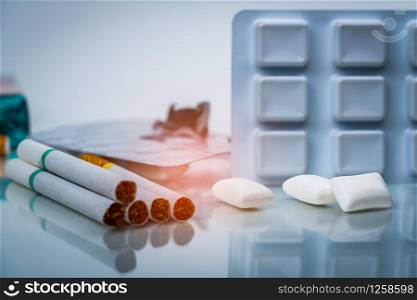 Nicotine chewing gum in blister pack near pile of cigarette. Quit smoking or smoking cessation and lung cancer concept. 31 May : World no tobacco day.