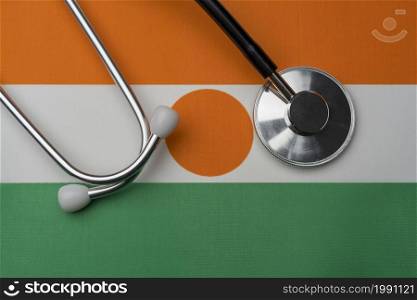 Niger flag and stethoscope. The concept of medicine. Stethoscope on the flag as a background.. Niger flag and stethoscope. The concept of medicine.