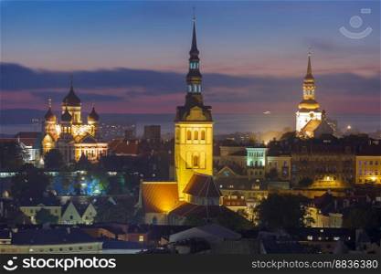 Night aerial cityscape with Medieval Old Town illuminated with Saint Nicholas Church, Cathedral Church of Saint Mary and Alexander Nevsky Cathedral in Tallinn, Estonia. Night aerial view old town, Tallinn, Estonia