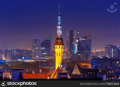 Night aerial cityscape with old town hall spire and modern office buildings skyscrapers in the background in Tallinn at blue hour, Estonia