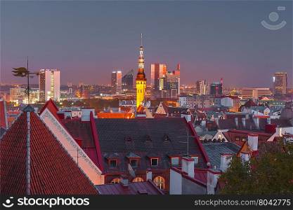 Night aerial cityscape with old town hall spire and modern office buildings skyscrapers in the background in Tallinn, Estonia