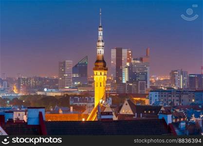 Night aerial cityscape with old town hall spire and modern office buildings skyscrapers in the background in Tallinn, Estonia. Night aerial cityscape of Tallinn, Estonia