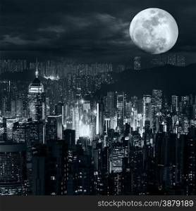 Night aerial view panorama of Hong Kong skyline at full moon night under dramatic cloudy sky