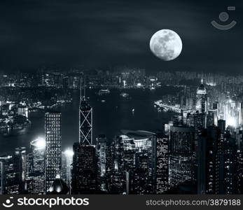 Night aerial view panorama of Hong Kong skyline at full moon night under cloudy sky