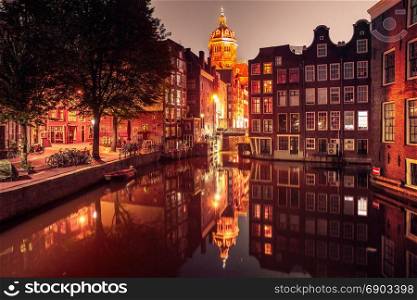 Night Amsterdam red-light district De Wallen. Night red-light district De Wallen, canal Oudezijds Voorburgwal, bridge, Basilica of Saint Nicholas and its mirror reflection, Amsterdam, Holland, Netherlands. Used toning