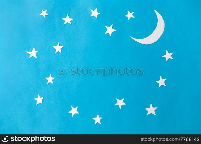 night, bedtime and object concept - moon and stars on blue paper background. moon and stars on blue night background