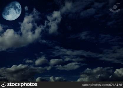 Night blue cloudy sky with stars and a moon crescent-shaped