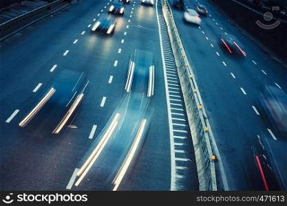 Night car traffic. Motion blur car viewed from the road bridge in big modern city.