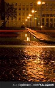 Night city after rain and puddle raflection