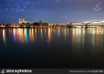 Night city and bridge across river