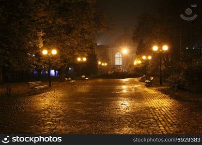 Night city park. night city park in Ivano-Frankivsk. Park night with lanterns and benches