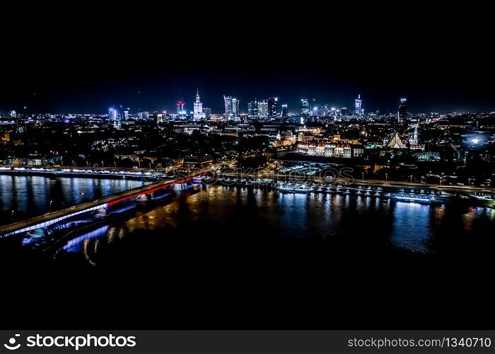 Night city skyline background. Aerial view of Warsaw capital city of Poland. From above, night city view with night sky. Night panorama of Warsaw cityscape. Aerial View