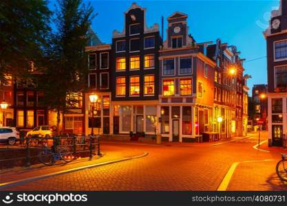 Night city view of Amsterdam bridge and typical dutch houses, Holland, Netherlands.