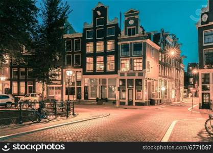 Night city view of Amsterdam bridge and typical dutch houses, Holland, Netherlands.. Toning in cool tones