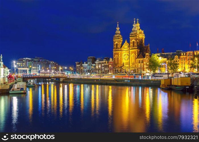 Night city view of Amsterdam canal and Basilica of Saint Nicholas, Holland, Netherlands. Long exposure.