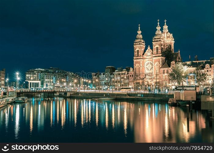 Night city view of Amsterdam canal and Basilica of Saint Nicholas, Holland, Netherlands. Long exposure.. Toning in cool tones