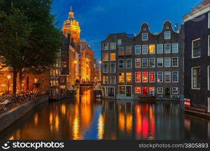 Night city view of Amsterdam canal, bridge and typical houses, Holland, Netherlands. Long exposure.