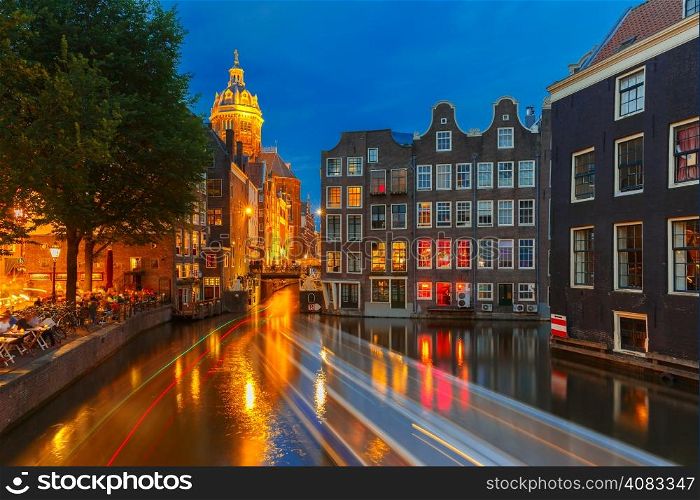 Night city view of Amsterdam canal, bridge and typical houses, Holland, Netherlands. Long exposure.