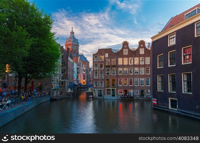 Night city view of Amsterdam canal, bridge and typical houses, Holland, Netherlands. Long exposure.