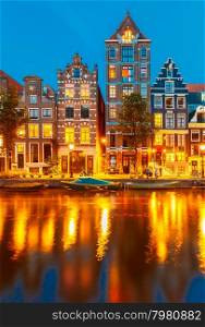 Night city view of Amsterdam canal Herengracht with typical dutch houses, Holland, Netherlands.