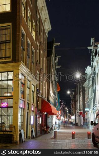 Night city view of Amsterdam street and typical houses, Holland, Netherlands.