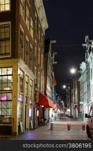 Night city view of Amsterdam street and typical houses, Holland, Netherlands.