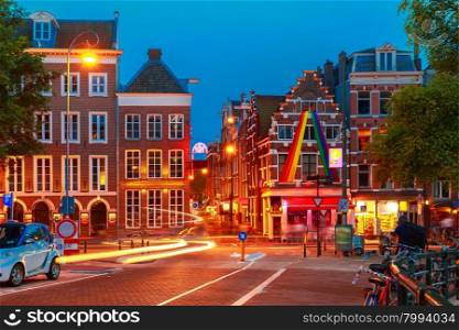 Night city view of Amsterdam street with typical dutch houses, Holland, Netherlands.
