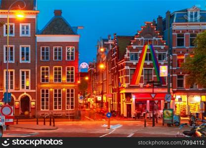 Night city view of Amsterdam street with typical dutch houses, Holland, Netherlands.