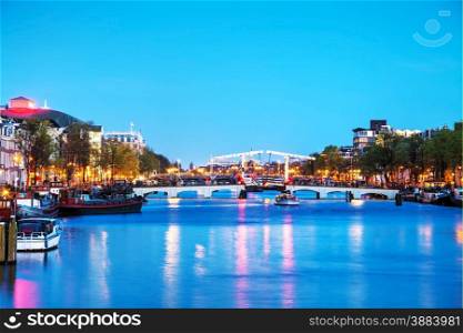 Night city view of Amsterdam, the Netherlands with Amstel river