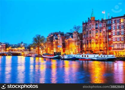 Night city view of Amsterdam, the Netherlands with the Amstel river