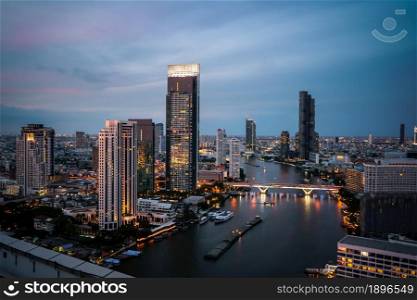 Night cityscape and high-rise buildings in metropolis city center . Downtown business district in panoramic view .. Night cityscape and high-rise buildings in metropolis city center